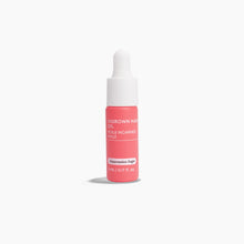 Load image into Gallery viewer, Pink bottle of hair oil with white cap on a white background