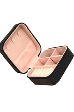 Load image into Gallery viewer, Jewelry box with pink interior compartments on a beige background

