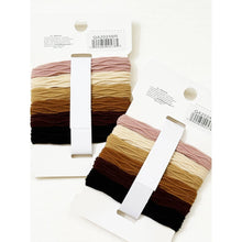 Load image into Gallery viewer, Neutral rolled hair ties displayed in assorted earthy tones on back of branded packaging
