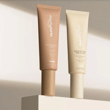 Load image into Gallery viewer, Two tubes of HydroPeptide Solar Defense sunscreen on a neutral background
